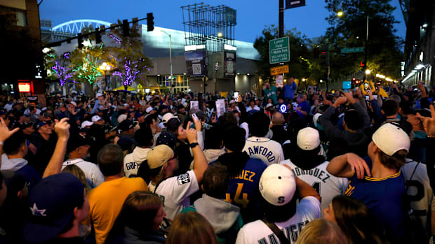 Mariners fans celebrate a victory in Game 5 of the ALCS over the Blue Jays
