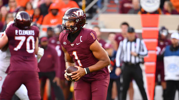 Nov 9, 2024; Blacksburg, Virginia, USA;  Virginia Tech Hokies quarterback Kyron Drones (1) runs the ball against the Clemson Tigers during the first quarter at Lane Stadium. Mandatory Credit: Brian Bishop-Imagn Images