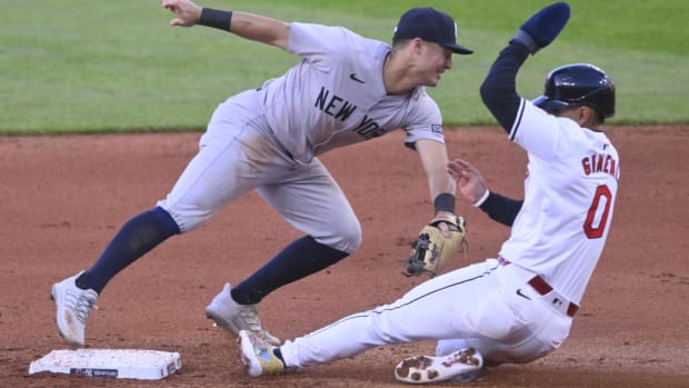 Andres Gimenez is forced out at second base by New York Yankees shortstop Anthony Volpe.