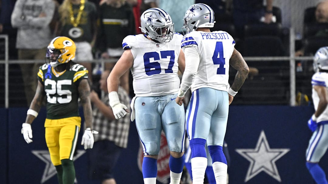 Sep 28, 2025; Arlington, Texas, USA; Dallas Cowboys quarterback Dak Prescott (4) celebrates with center Brock Hoffman (67) after a touchdown in the second quarter against the Green Bay Packers at AT&T Stadium. Mandatory Credit: Jerome Miron-Imagn Images