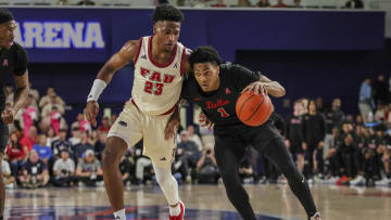 Feb 22, 2024; Boca Raton, Florida, USA; Southern Methodist Mustangs guard Zhuric Phelps (1) drives to the basket against Florida Atlantic Owls guard Brandon Weatherspoon (23) during the first half at Eleanor R. Baldwin Arena. Mandatory Credit: Sam Navarro-USA TODAY Sports