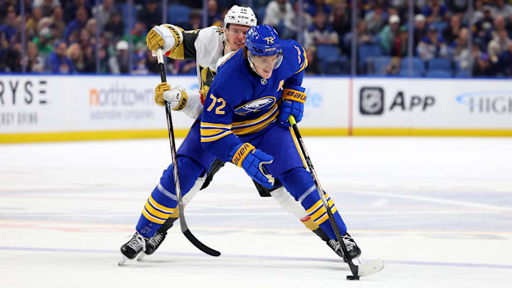 Mar 15, 2025; Buffalo, New York, USA;  Buffalo Sabres center Tage Thompson (72) skates with the puck as Vegas Golden Knights left wing Pavel Dorofeyev (16) defends during overtime at KeyBank Center. Mandatory Credit: Timothy T. Ludwig-Imagn Images