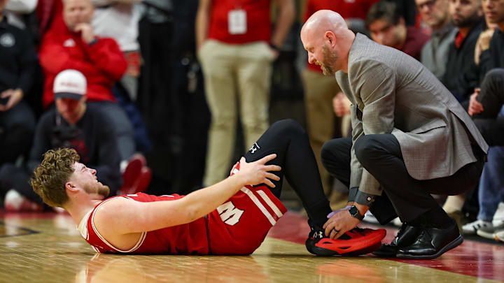 Jan 6, 2025; Piscataway, New Jersey, USA; Wisconsin Badgers guard Max Klesmit (11) is looked at by medical staff during the second half against the Rutgers Scarlet Knights at Jersey Mike's Arena. Mandatory Credit: Vincent Carchietta-Imagn Images