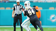 Nov 30, 2025; Miami Gardens, Florida, USA; New Orleans Saints defensive end Cameron Jordan (94) applies pressure on Miami Dolphins quarterback Tua Tagovailoa (1) during the first half at Hard Rock Stadium. Mandatory Credit: Rich Storry-Imagn Images