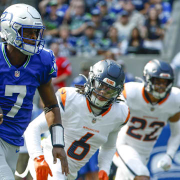 Sep 8, 2024; Seattle, Washington, USA; Seattle Seahawks quarterback Geno Smith (7) rushes for a touchdown against the Denver Broncos during the second quarter at Lumen Field.