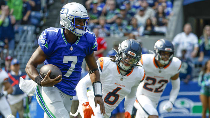 Sep 8, 2024; Seattle, Washington, USA; Seattle Seahawks quarterback Geno Smith (7) rushes for a touchdown against the Denver Broncos during the second quarter at Lumen Field.