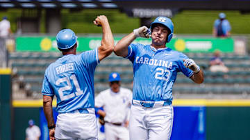 May 23, 2024; Charlotte, NC, USA; North Carolina Tar Heels designated hitter Alberto Osuna (23) celebrates a home run with head coach Scott Forbes in the first inning against the Pittsburgh Panthers during the ACC Baseball Tournament at Truist Field. Mandatory Credit: Scott Kinser-Imagn Images