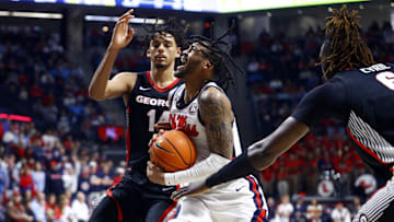 Jan 4, 2025; Oxford, Mississippi, USA; Mississippi Rebels guard Dre Davis (14) drives to the basket between Georgia Bulldogs forward Asa Newell (14) and center Somtochukwu Cyril (6) during the second half at The Sandy and John Black Pavilion at Ole Miss. Mandatory Credit: Petre Thomas-Imagn Images