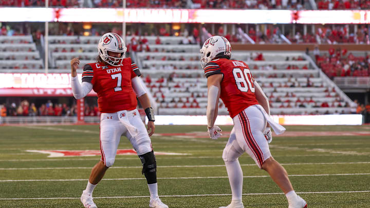 Aug 29, 2024; Salt Lake City, Utah, USA; Utah Utes quarterback Cameron Rising (7) and tight end Brant Kuithe (80) celebrate a touchdown against the Southern Utah Thunderbirds during the second quarter at Rice-Eccles Stadium. Mandatory Credit: Rob Gray-Imagn Images