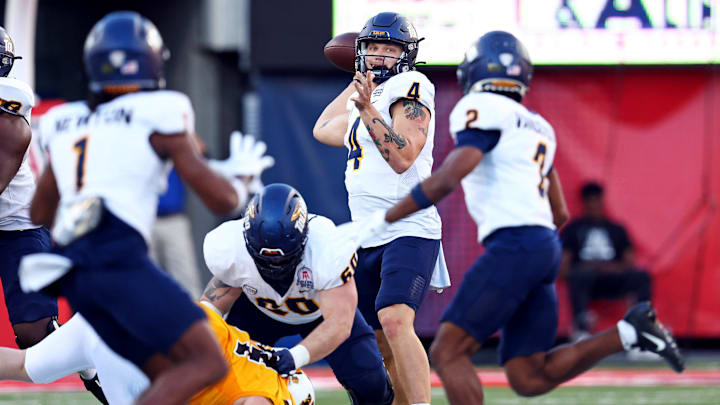 Toledo Rockets quarterback Tucker Gleason (4) throws a pass to wide receiver Junior Vandeross III (2) during the second half against the Wyoming Cowboys in the Arizona Bowl at Arizona Stadium.