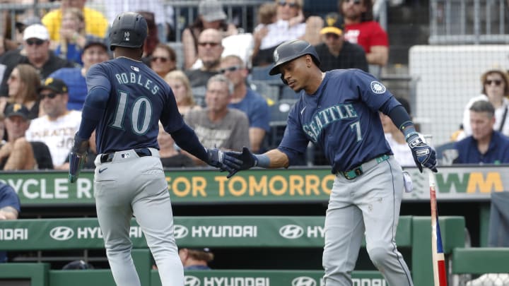 Seattle Mariners second baseman Jorge Polanco (7) greets center fielder Victor Robles (10) returning to the dugout after Robles scored a run against the Pittsburgh Pirates during the fourth inning at PNC Park on Aug 18.