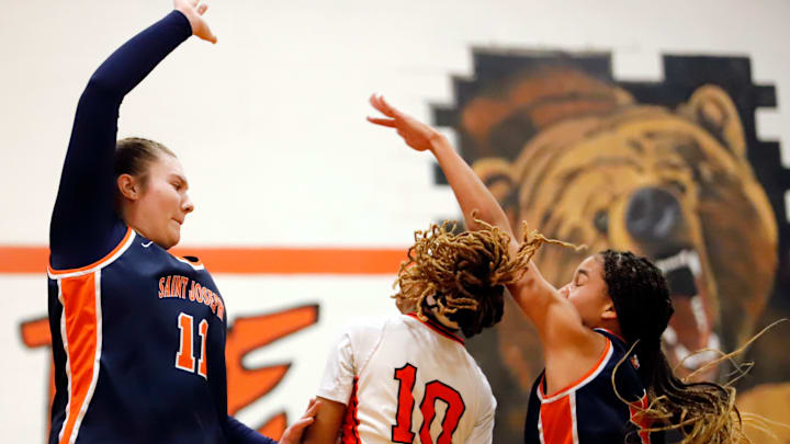 Saint Joseph Catholic Academy junior forwards Aubrey Yartz, left, and Jacee Cuningham, right, team up to try and slow down Clairton senior guard Iyanna Wade Saturday afternoon at Paulette Bradford Memorial Gymnasium. The Wolfpack limited Wade, who averages over 40 points per game, to 24 during a PIAA Class A first-round playoff game. Saint Joseph Catholic Academy junior forwards Aubrey Yartz, left, and Jacee Cuningham, right, team up to try and slow down Clairton senior guard Iyanna Wade Saturday afternoon at Paulette Bradford Memorial Gymnasium. The Wolfpack limited Wade, who averages over 40 points per game, to 24 during a PIAA Class A first-round playoff game.