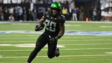 Dec 7, 2024; Indianapolis, IN, USA; Oregon Ducks running back Jordan James (20) runs for a gain against the Penn State Nittany Lions during the fourth quarter in the 2024 Big Ten Championship game at Lucas Oil Stadium.