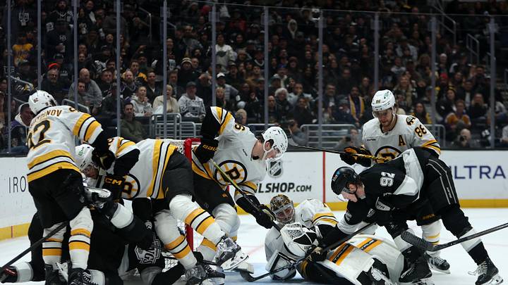 Nov 21, 2025; Los Angeles, California, USA;  Los Angeles Kings defenseman Brandt Clarke (92) attempts to score against Boston Bruins goaltender Jeremy Swayman (1) during the second period at Crypto.com Arena. Mandatory Credit: Kiyoshi Mio-Imagn Images
