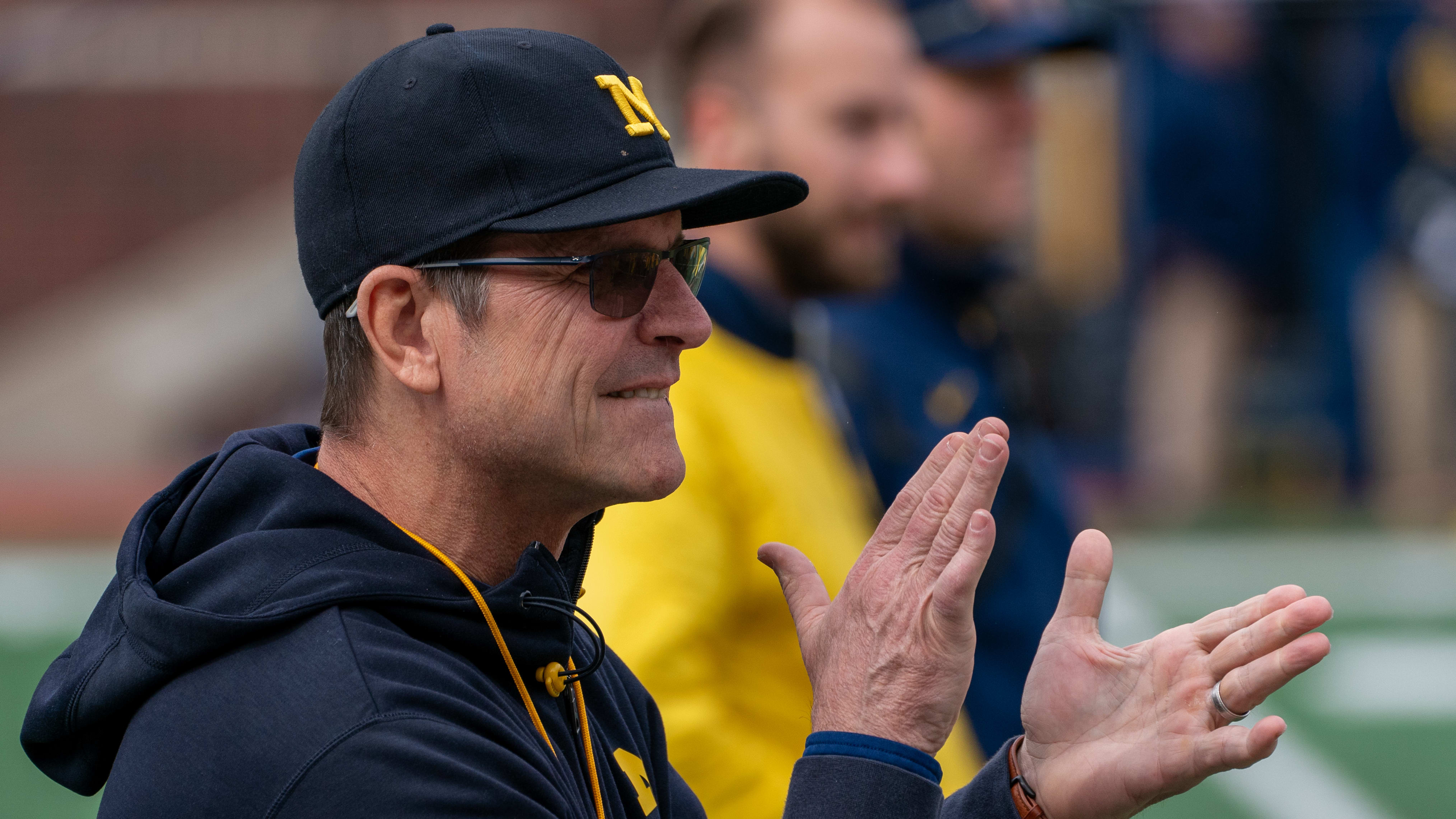 Ex-Michigan head coach Jim Harbaugh takes part in the Wolverines' spring football game.