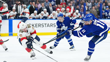 Mar 13, 2025; Toronto, Ontario, CAN; Toronto Maple Leafs center Max Domi (11) shoots the puck past Florida Panthers defenseman Nate Schmidt (88) scoring a goal during the third period at Scotiabank Arena. Mandatory Credit: Nick Turchiaro-Imagn Images