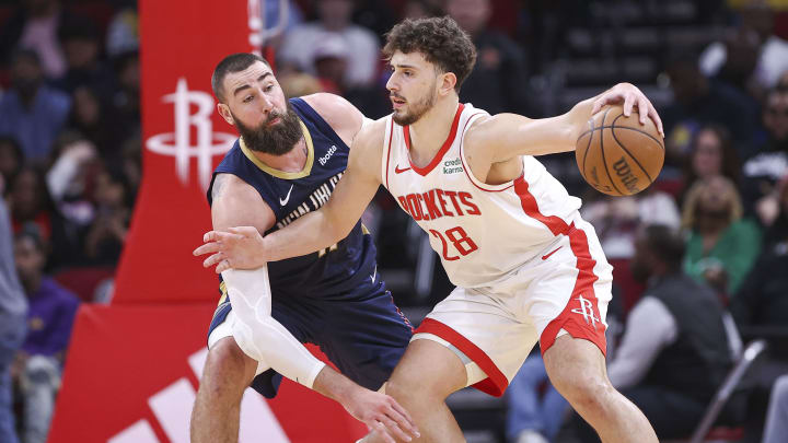 Jan 31, 2024; Houston, Texas, USA; Houston Rockets center Alperen Sengun (28) controls the ball as New Orleans Pelicans center Jonas Valanciunas (17) defends during the second quarter at Toyota Center. Mandatory Credit: Troy Taormina-USA TODAY Sports