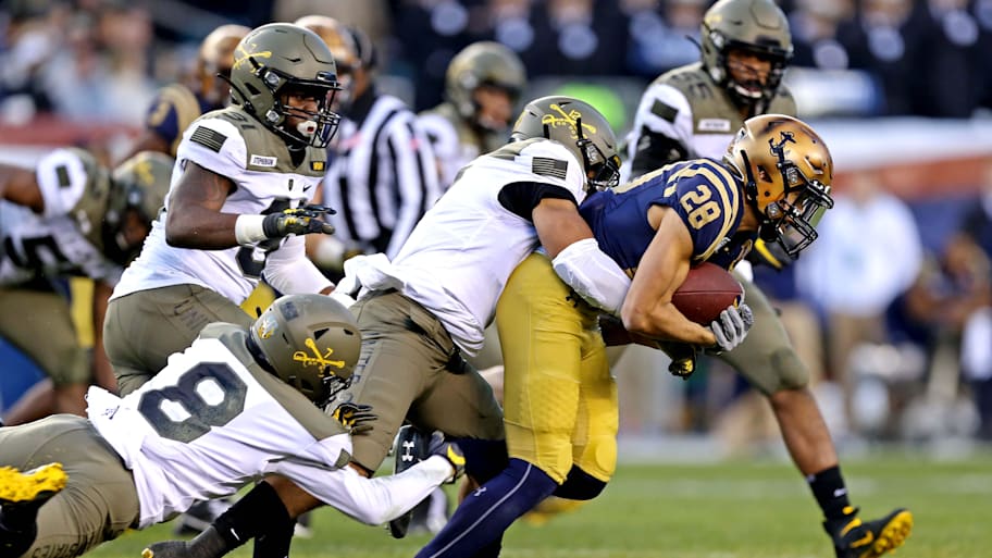 Army defenders tackle Navy Midshipment wide receiver Keoni-Kordell Makekau during the 2019 Army-Navy Game.