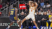 Oct 8, 2024; Atlanta, Georgia, USA; Atlanta Hawks guard Dyson Daniels (5) controls the ball in front of Indiana Pacers forward Aaron Nesmith (23) during the first half at State Farm Arena. Mandatory Credit: Dale Zanine-Imagn Images
