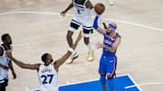 May 22, 2025; Oklahoma City, Oklahoma, USA; Oklahoma City Thunder guard Alex Caruso (9) shoots against Minnesota Timberwolves center Rudy Gobert (27) in the second quarter during game two of the western conference finals for the 2025 NBA Playoffs at Paycom Center. Mandatory Credit: Brett Rojo-Imagn Images