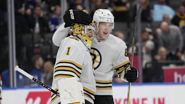 Mar 4, 2024; Toronto, Ontario, CAN; Boston Bruins goaltender Jeremy Swayman (1) and defenseman Mason Lohrei (6) celebrate a win over the Toronto Maple Leafs at Scotiabank Arena. Mandatory Credit: John E. Sokolowski-Imagn Images