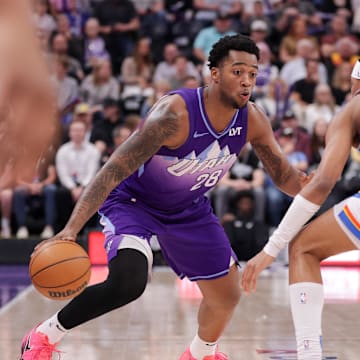Apr 11, 2025; Salt Lake City, Utah, USA;  Utah Jazz forward Brice Sensabaugh (28) tries to dribble past Oklahoma City Thunder guard Aaron Wiggins (21) during the second half at Delta Center. Mandatory Credit: Chris Nicoll-Imagn Images