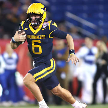 Dec 17, 2024; Frisco, TX, USA; West Virginia Mountaineers quarterback Garrett Greene (6) runs for a touchdown against the Memphis Tigers in the second quarter at Toyota Stadium. Mandatory Credit: Tim Heitman-Imagn Images