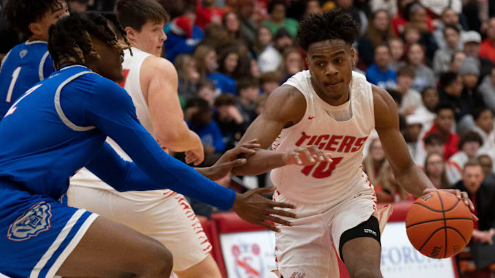 Fishers Tigers guard Jalen Haralson (10) dribbles towards the hoop.