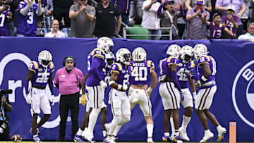 Dec 31, 2024; Houston, TX, USA; LSU Tigers linebacker Davhon Keys (42) celebrates his interception for a touchdown during the first quarter against the Baylor Bears at NRG Stadium. Mandatory Credit: Maria Lysaker-Imagn Images 