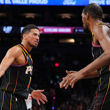 Phoenix Suns guard Booker and former Suns forward Durant high five at Footprint Center.