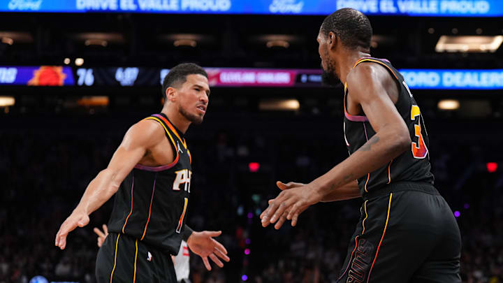 Phoenix Suns guard Booker and former Suns forward Durant high five at Footprint Center.