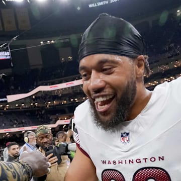 New Orleans Saints linebacker Demario Davis greets former teammate Washington Commanders cornerback Marshon Lattimore.