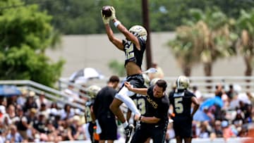 Wide receiver Chris Olave catches a pass during New Orleans Saints Mandatory Minicamp