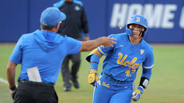 UCLA's Megan Grant (43) is tossed a piece of candy after hitting a home run in the second inning of a Women's College World Series softball game between the Stanford Cardinal and the UCLA Bruins at Devon Park in Oklahoma City, Sunday, June 2, 2024. Stanford won 3-1.