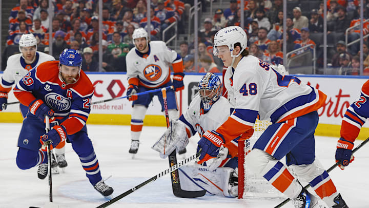 Jan 15, 2026; Edmonton, Alberta, CAN; New York Islanders defensemen Matthew Schaefer (48) and Edmonton Oilers forward Leon Draisaitl (29) chase a loose puck during the first period at Rogers Place. Mandatory Credit: Perry Nelson-Imagn Images