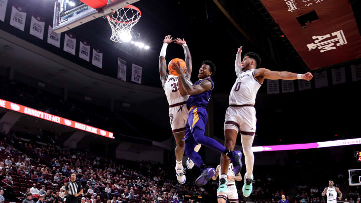 Dec 30, 2023; College Station, Texas, USA; Prairie View A&M Panthers guard Javontae Hopkins (14) attempts a layup against Texas A&M Aggies guard Manny Obaseki (35) and Texas A&M Aggies guard Jace Carter (0) during the second half at Reed Arena. Mandatory Credit: Erik Williams-USA TODAY Sports
