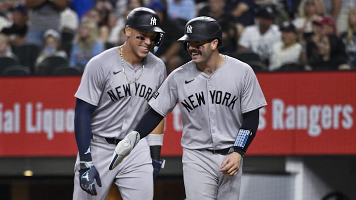 Sep 2, 2024; Arlington, Texas, USA; New York Yankees catcher Austin Wells (right) and center fielder Aaron Judge (left) laugh at home plate as they both score on a ground rule double hit by first baseman Anthony Rizzo (not pictured) during the sixth inning at Globe Life Field. Mandatory Credit: Jerome Miron-Imagn Images