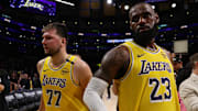 Apr 22, 2025; Los Angeles, California, USA; Los Angeles Lakers guard Luka Doncic (77) and Los Angeles Lakers forward LeBron James (23) leave a court after defeating the Minnesota Timberwolves 94-85 in game two of first round for the 2024 NBA Playoffs at Crypto.com Arena. Mandatory Credit: Kiyoshi Mio-Imagn Images