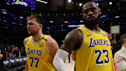 Apr 22, 2025; Los Angeles, California, USA; Los Angeles Lakers guard Luka Doncic (77) and Los Angeles Lakers forward LeBron James (23) leave a court