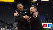 Nov 16, 2024; Sacramento, California, USA; Sacramento Kings guard De'Aaron Fox (left) and assistant coach Luke Loucks (right) before the game against the Utah Jazz at Golden 1 Center. Mandatory Credit: Darren Yamashita-Imagn Images