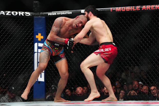 Alex Pereira (red gloves) fights Magomed Ankalaev (blue gloves) during UFC 313 at T-Mobile Arena. 