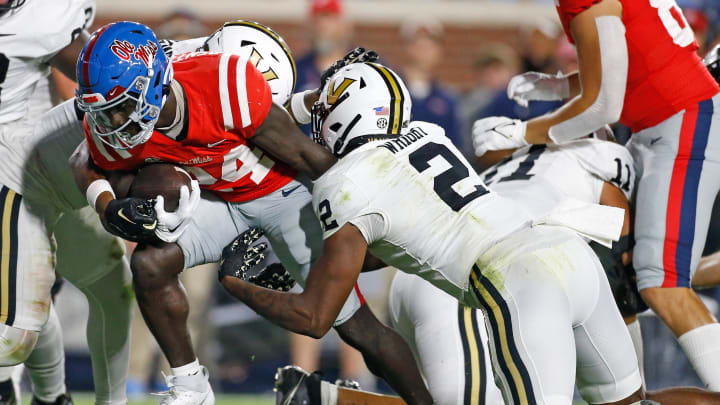 Oct 28, 2023; Oxford, Mississippi, USA; Mississippi Rebels running back Ulysses Bentley IV (24) runs the ball as Vanderbilt Commodores defensive back De'Rickey Wright (2) make the tackle during the first half at Vaught-Hemingway Stadium. Mandatory Credit: Petre Thomas-USA TODAY Sports