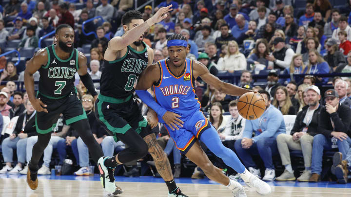 Jan 2, 2024; Oklahoma City, Oklahoma, USA; Oklahoma City Thunder guard Shai Gilgeous-Alexander (2) drives to the basket against Boston Celtics forward Jayson Tatum (0) during the second quarter at Paycom Center. Mandatory Credit: Alonzo Adams-USA TODAY Sports