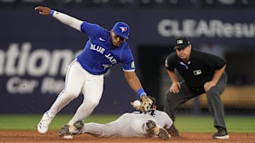 Jul 3, 2025; Toronto, Ontario, CAN; New York Yankees left fielder Jasson Dominguez (24) steals second base as Toronto Blue Jays second baseman Leo Jimenez (49) bobbles the throw during the fifth inning at Rogers Centre. Mandatory Credit: John E. Sokolowski-Imagn Images