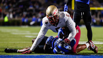 Oct 18, 2024; Durham, North Carolina, USA; Duke Blue Devils quarterback Maalik Murphy (6) attempts to run the ball to the end zone but is tacked by Florida State Seminoles defensive lineman Darrell Jackson Jr. (6) during the first half of the game at Wallace Wade Stadium. Mandatory Credit: Jaylynn Nash-Imagn Images
