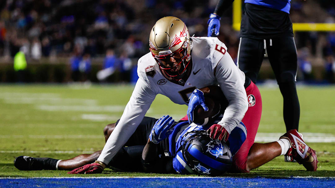 Oct 18, 2024; Durham, North Carolina, USA; Duke Blue Devils quarterback Maalik Murphy (6) is tacked by Florida State Seminoles defensive lineman Darrell Jackson Jr. (6).