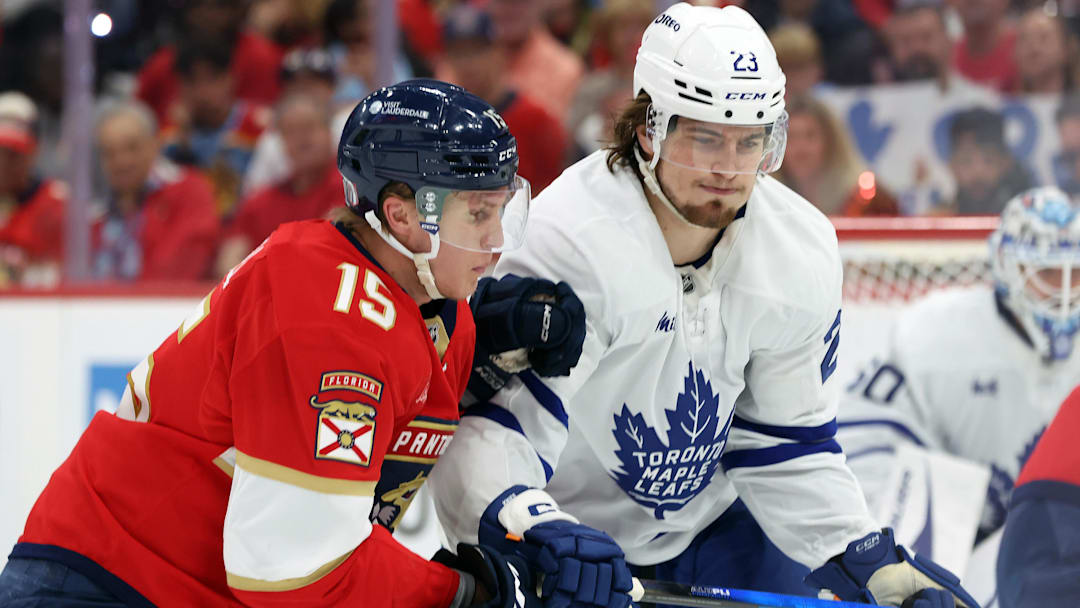 May 11, 2025; Sunrise, Florida, USA; Florida Panthers center Anton Lundell (15) and Toronto Maple Leafs left wing Matthew Knies (23) skate after the puck during the second period in game four of the second round of the 2025 Stanley Cup Playoffs at Amerant Bank Arena. Mandatory Credit: Kim Klement Neitzel-Imagn Images