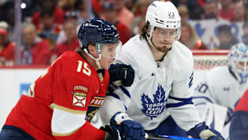 May 11, 2025; Sunrise, Florida, USA; Florida Panthers center Anton Lundell (15) and Toronto Maple Leafs left wing Matthew Knies (23) skate after the puck during the second period in game four of the second round of the 2025 Stanley Cup Playoffs at Amerant Bank Arena. Mandatory Credit: Kim Klement Neitzel-Imagn Images