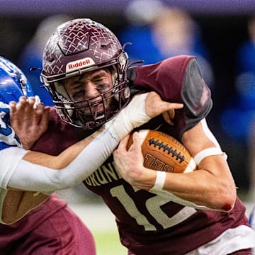 Grundy Center's Judd Jirovsky (12) runs the ball up the middle on Thursday, Nov. 21, 2024, at the UNI-Dome in Cedar Falls, IA.