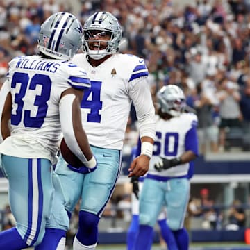 Sep 14, 2025; Arlington, Texas, USA; Dallas Cowboys running back Javonte Williams (33) celebrates with quarterback Dak Prescott (4) after scoring a touchdown against the New York Giants during the third quarter.